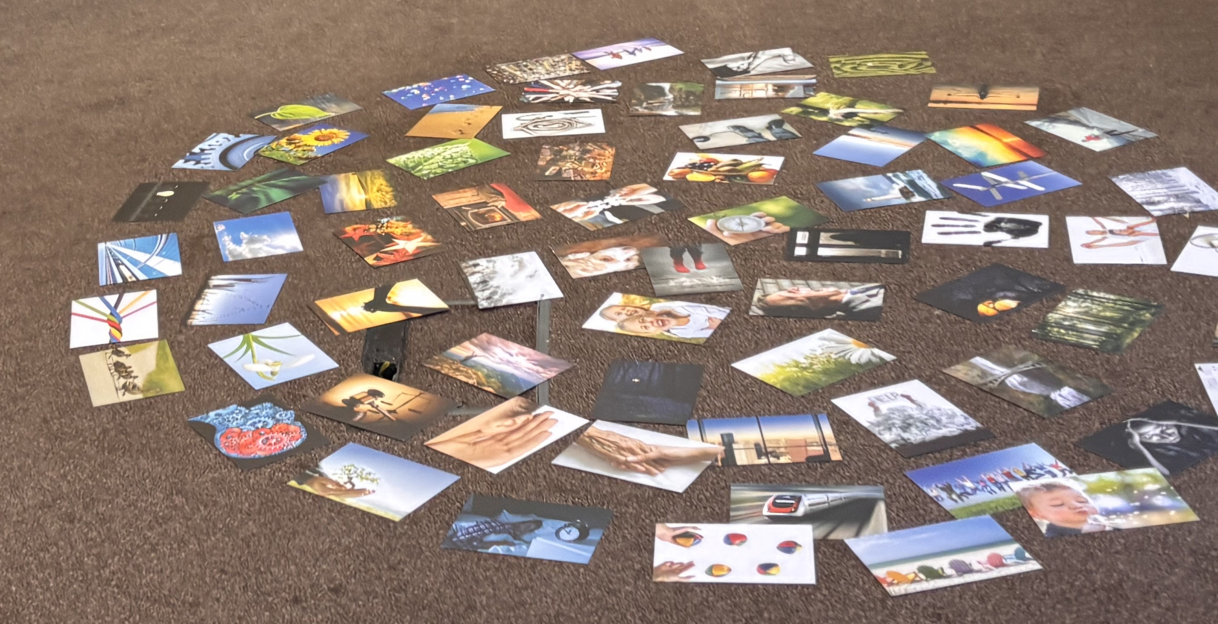 A colour image that shows a collection of photographs spread across a surface