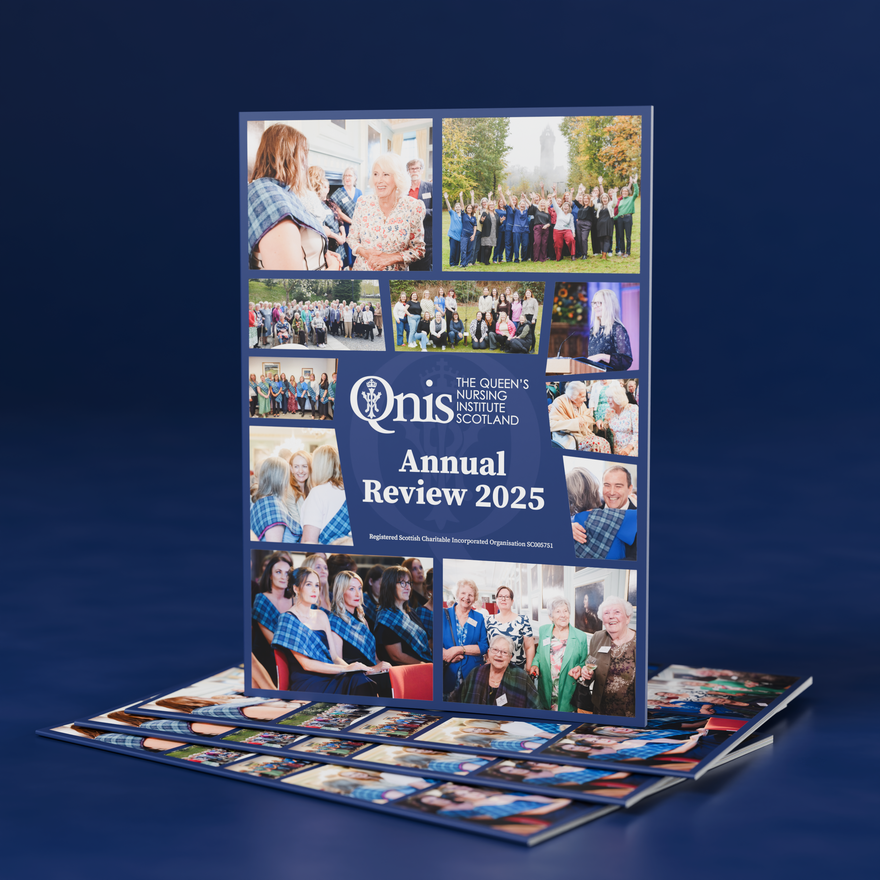 Image shows a report with A standing booklet titled “The Queen’s Nursing Institute Scotland Annual Review 2025,” shown against a dark blue background. The cover features a collage of photographs showing groups of people smiling, talking, celebrating outdoors, attending events, and embracing, representing community, healthcare, and connection. Several copies of the booklet are stacked flat beneath the main one.